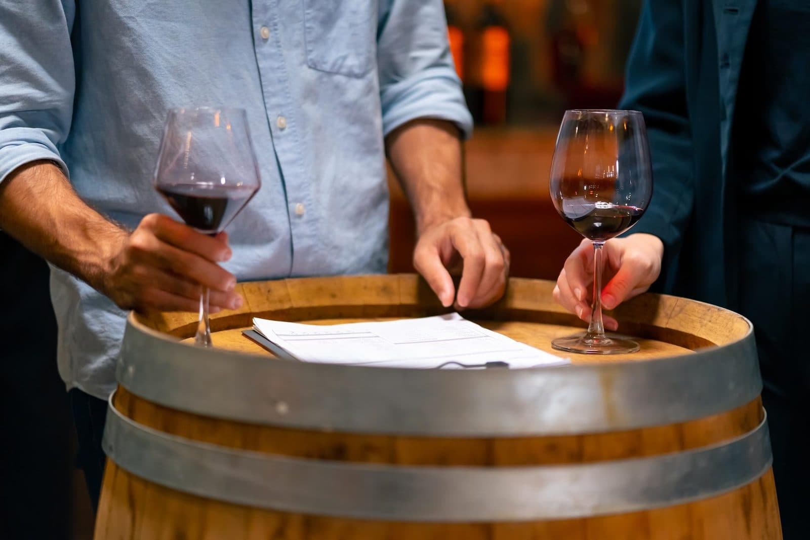Two glasses of red wine over a barrel and a tasting sheet. Avanos Wine Tasting, arranged from The Owl Cave Hotel in Göreme, Cappadocia.