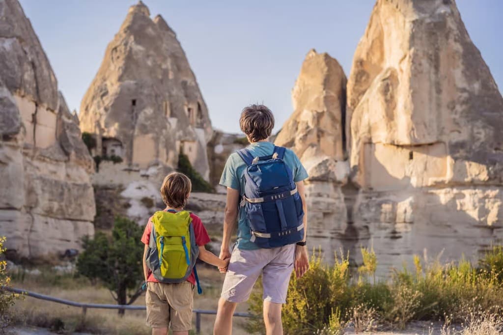 Father and child looking at fairy chimneys on the Cappadocia Red Tour arranged from The Owl Cave Hotel, Göreme