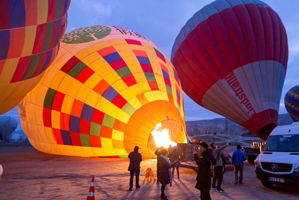 Crew inflating a balloon with the burner before take-off on the Göreme Sunrise Balloon Flight from The Owl Cave Hotel, Cappadocia