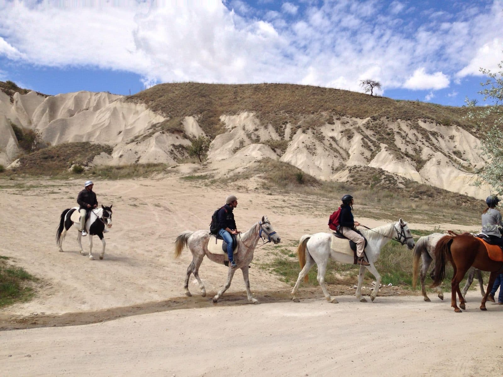 Three riders on a dirt track. Fairy Chimney Horse Ride, arranged from The Owl Cave Hotel in Göreme, Cappadocia.
