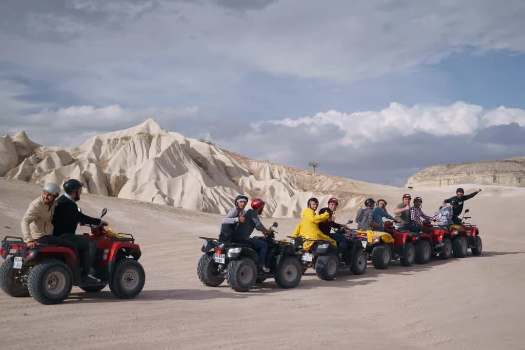 Small group of ATVs on white tuff hills on the bookable Göreme Quad Safari from The Owl Cave Hotel, Göreme