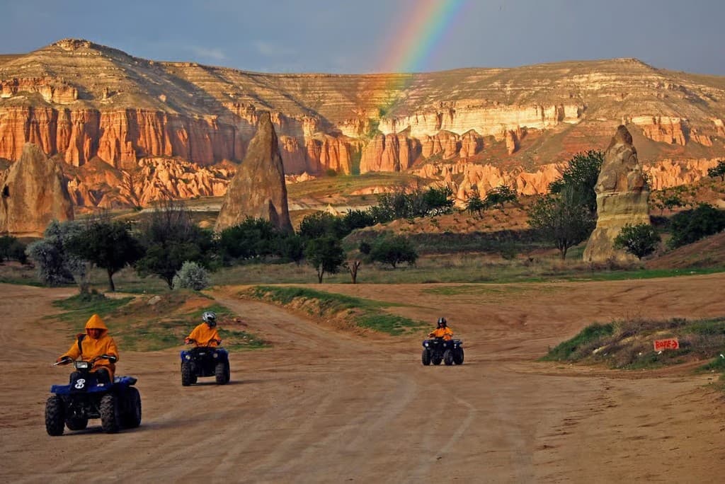 Guided ATV ride under a rainbow in Red Valley on the Göreme Quad Safari from The Owl Cave Hotel, Göreme, Cappadocia