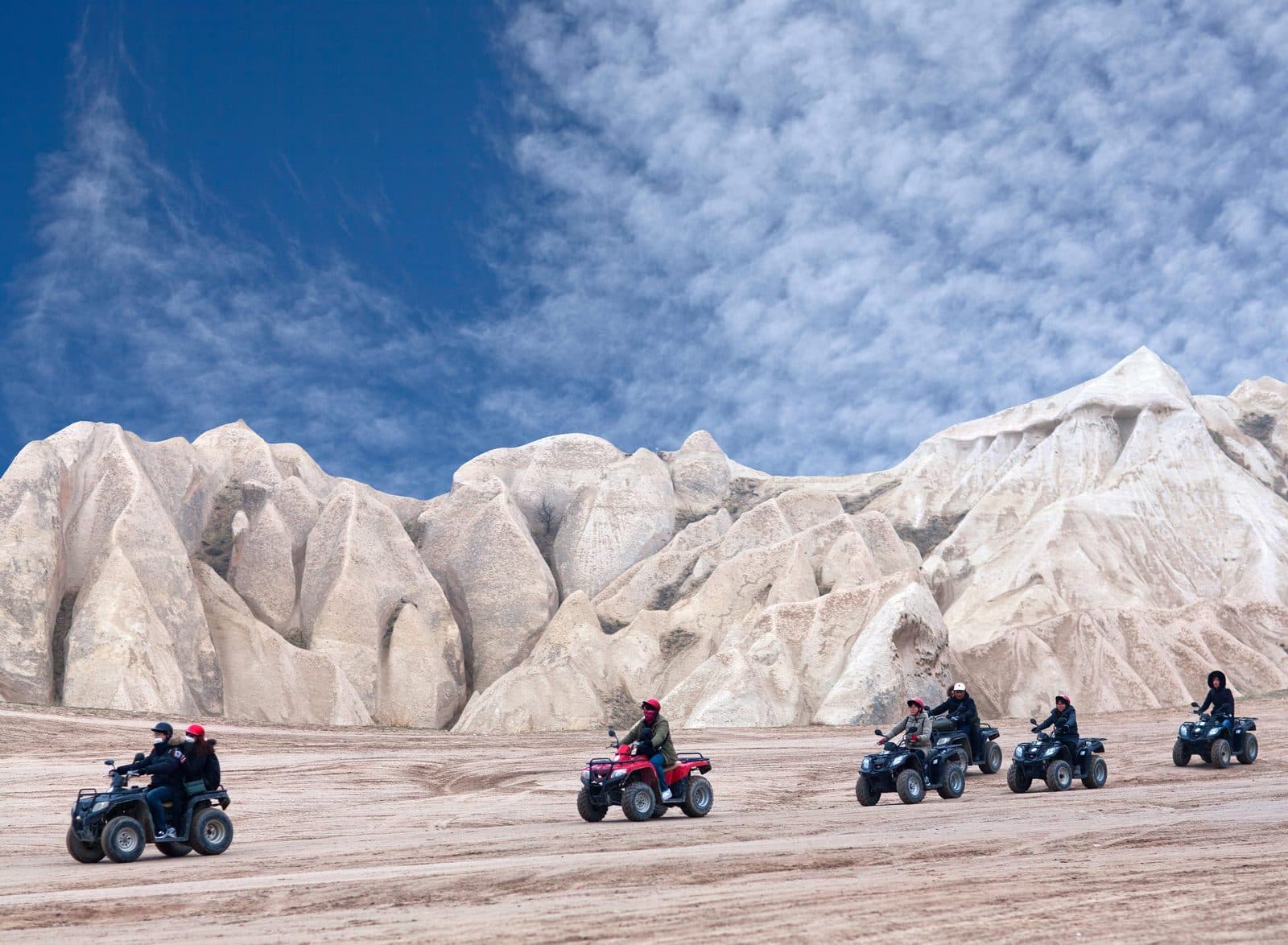 ATVs crossing a white-rock plateau. Sunset ATV Safari, arranged from The Owl Cave Hotel in Göreme, Cappadocia.
