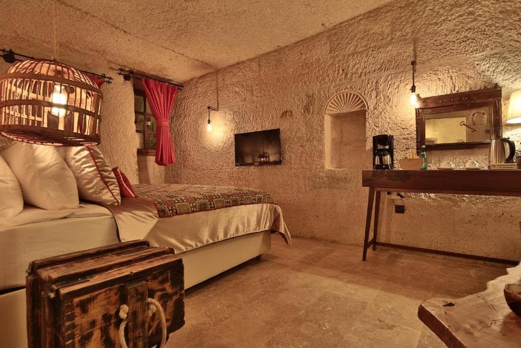 Coffee machine and flat-screen TV in the bookable Cave Suite at The Owl Cave Hotel, Göreme, Cappadocia