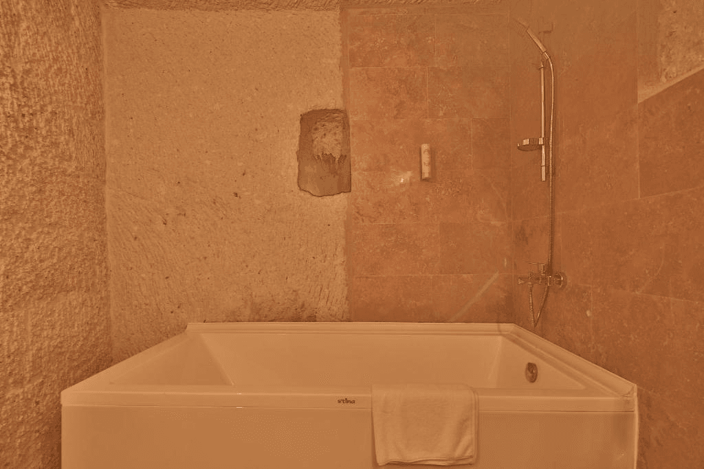 Private bathroom with bath in the Cave Suite at The Owl Cave Hotel, Göreme, Cappadocia