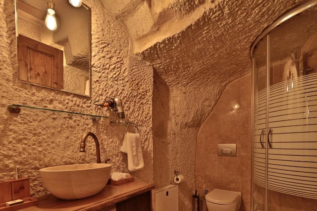 Private bathroom with shower in the Deluxe Arch Room with View at The Owl Cave Hotel, Göreme, Cappadocia