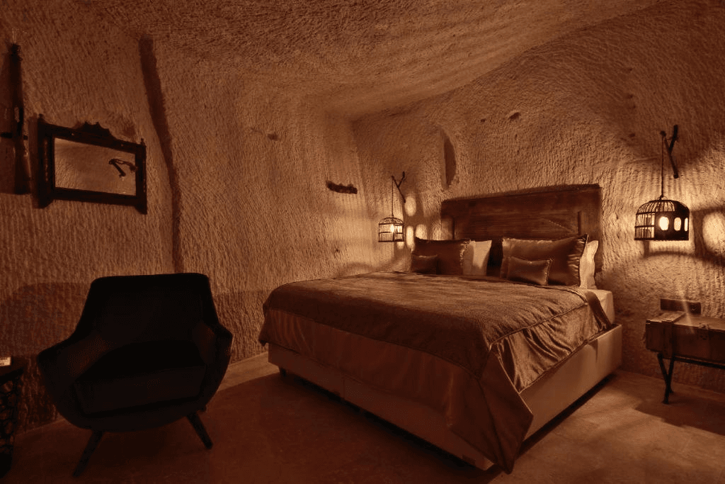 Family Suite queen bed in a cave bedroom at The Owl Cave Hotel, a bookable suite for up to four guests in Göreme, Cappadocia