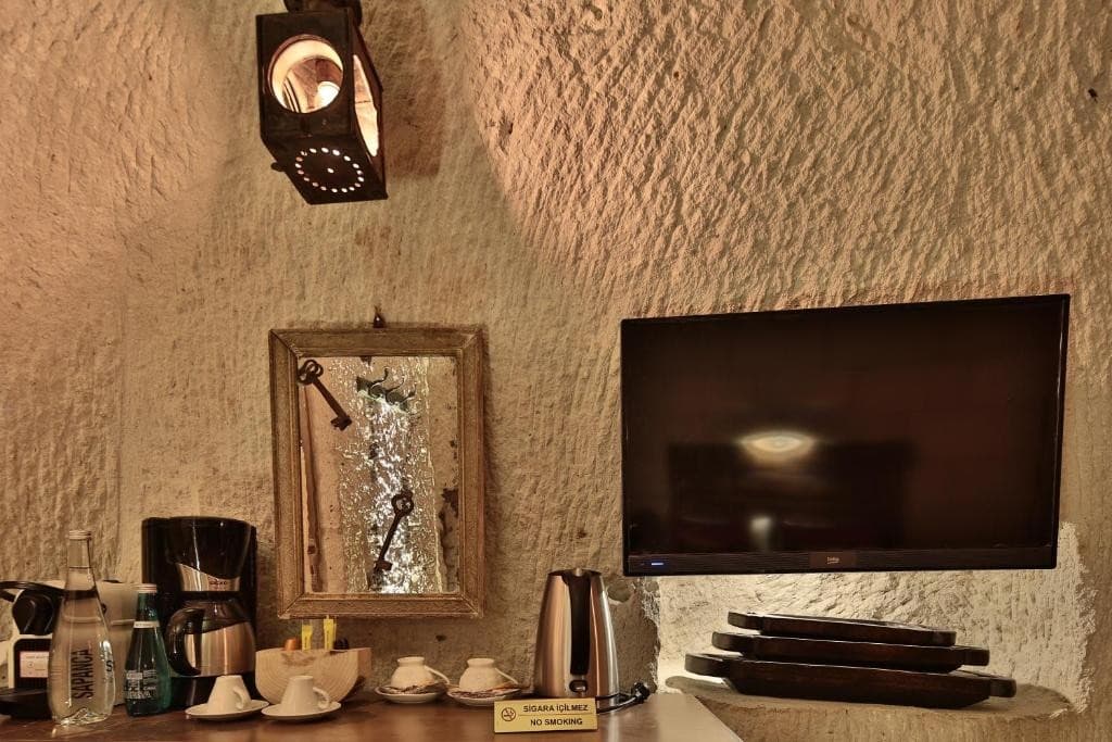 Coffee machine and flat-screen TV in the bookable Premier Cave Room at The Owl Cave Hotel, Göreme, Cappadocia