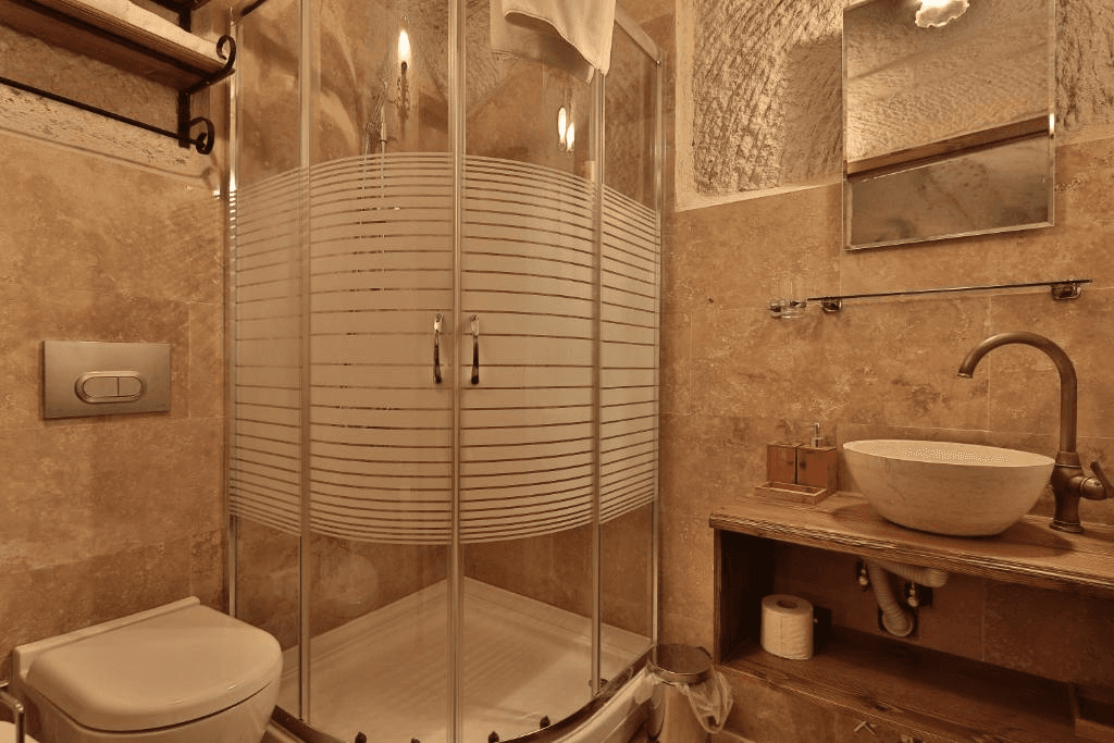 Private bathroom with shower in the Premier Cave Room at The Owl Cave Hotel, a bookable cave room in Göreme