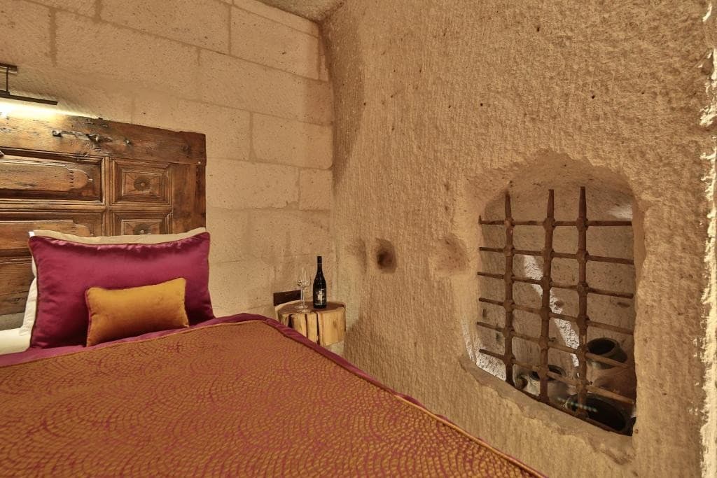 Carved tuff niche with iron grate in the Premier Cave Room at The Owl Cave Hotel in Göreme, Cappadocia