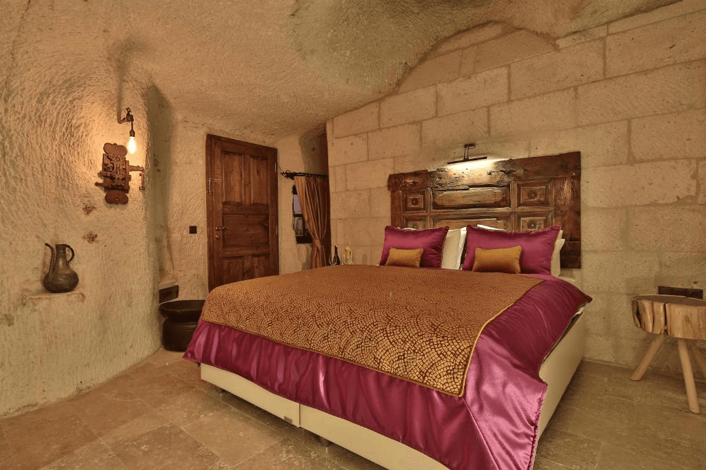Bookable Premier Cave Room king bed in a volcanic tuff cave at The Owl Cave Hotel, Göreme, Cappadocia