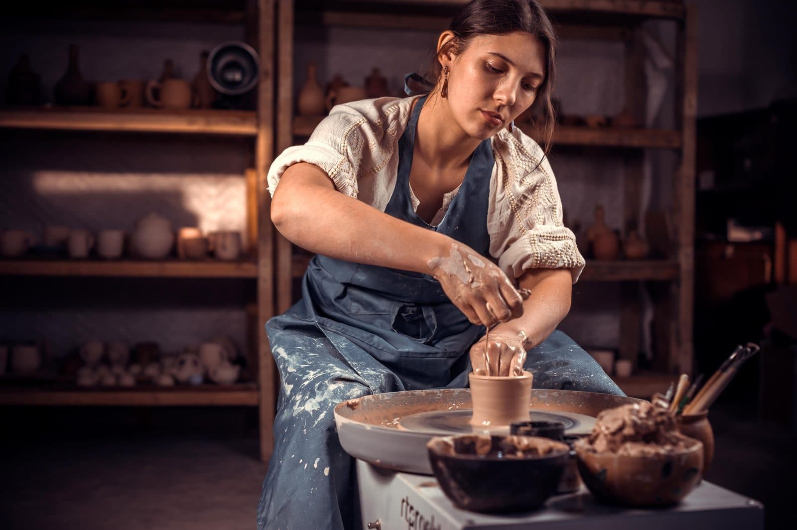 A woman shaping clay on a potter’s wheel. Avanos Pottery Workshop, arranged from The Owl Cave Hotel in Göreme, Cappadocia.