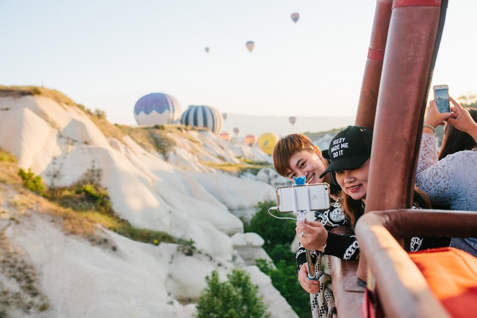 Guests in a balloon basket photographing other balloons. Sunrise Balloon and Cappadocia Day, arranged from The Owl Cave Hotel in Göreme, Cappadocia.