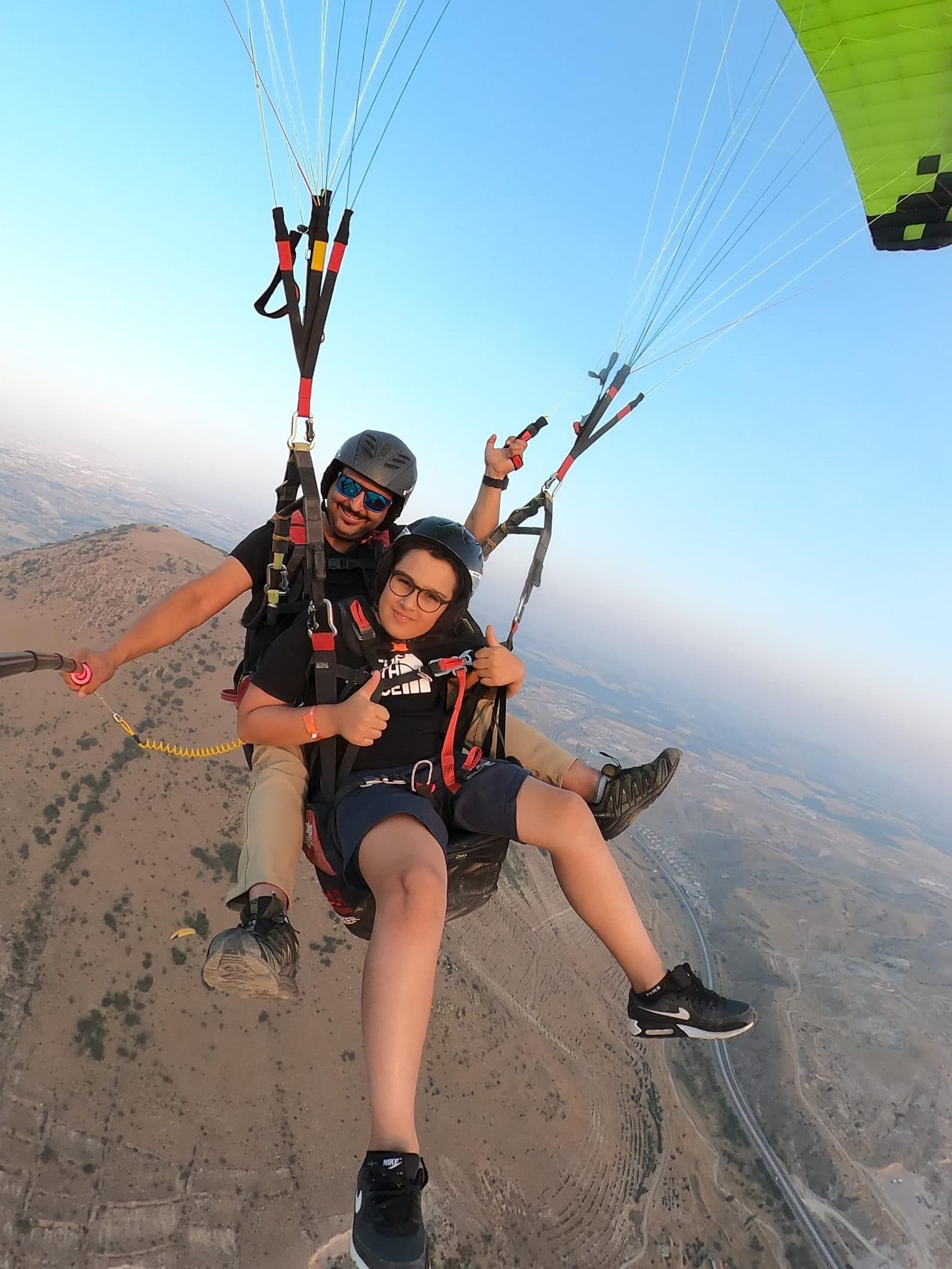 A tandem selfie against a clear blue sky. Tandem Paragliding, arranged from The Owl Cave Hotel in Göreme, Cappadocia.