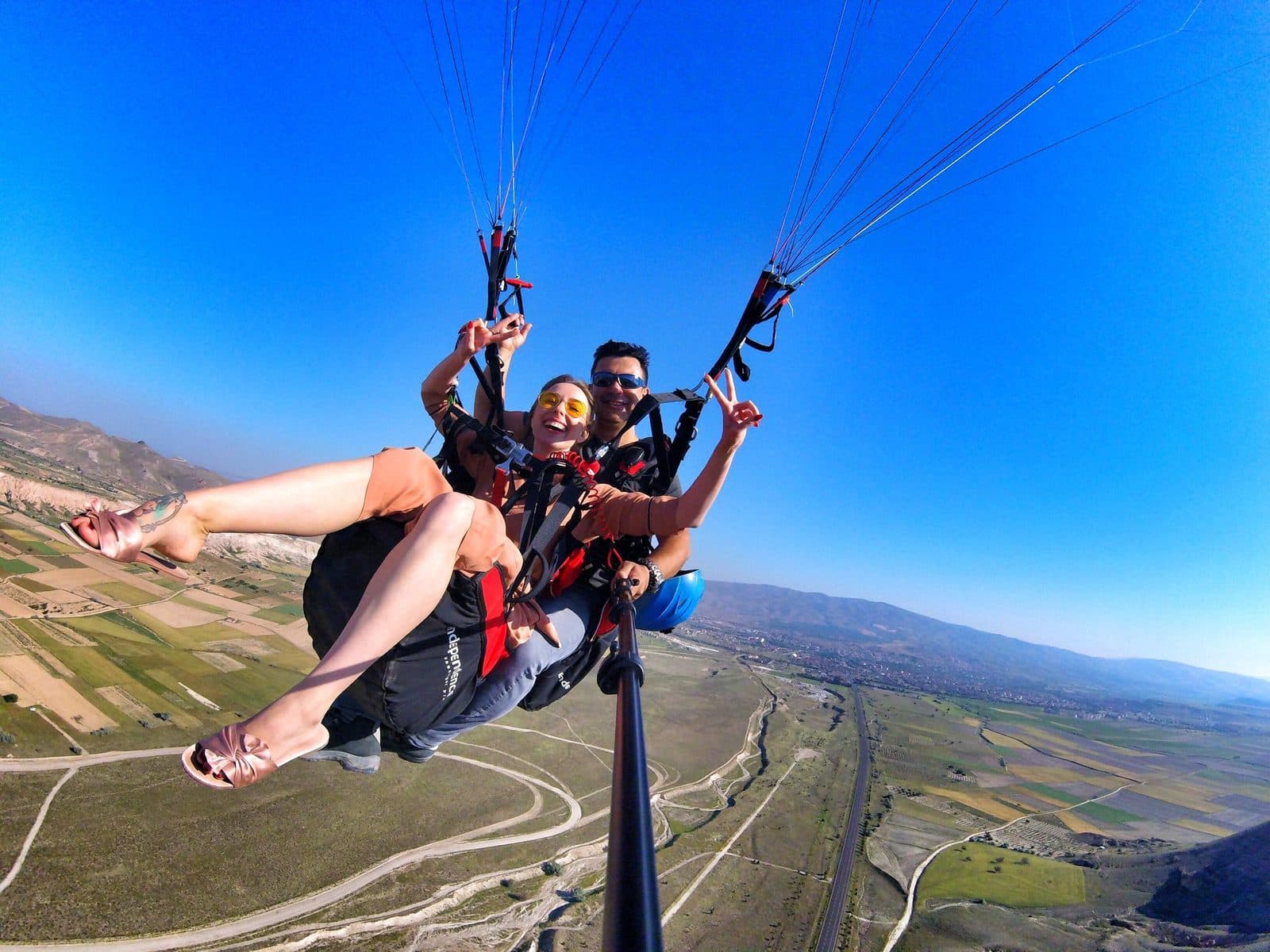 A tandem selfie high over the fields. Tandem Paragliding, arranged from The Owl Cave Hotel in Göreme, Cappadocia.
