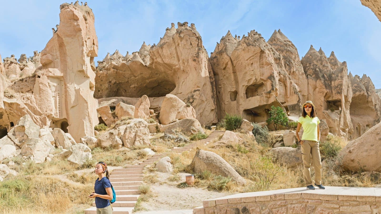 Two guests among tall fairy chimneys. Cappadocia Red and Green Day, arranged from The Owl Cave Hotel in Göreme, Cappadocia.