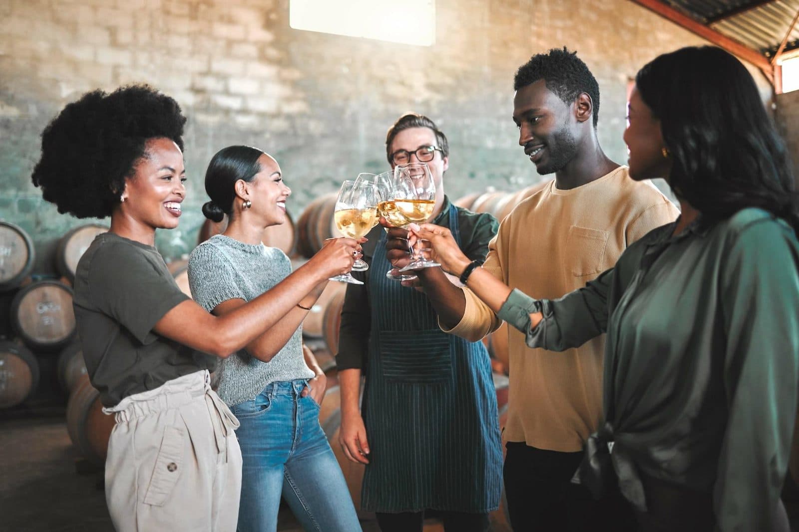 A group toasting in a stone cellar lined with barrels. Fairy Chimneys and Wine Tasting, arranged from The Owl Cave Hotel in Göreme, Cappadocia.