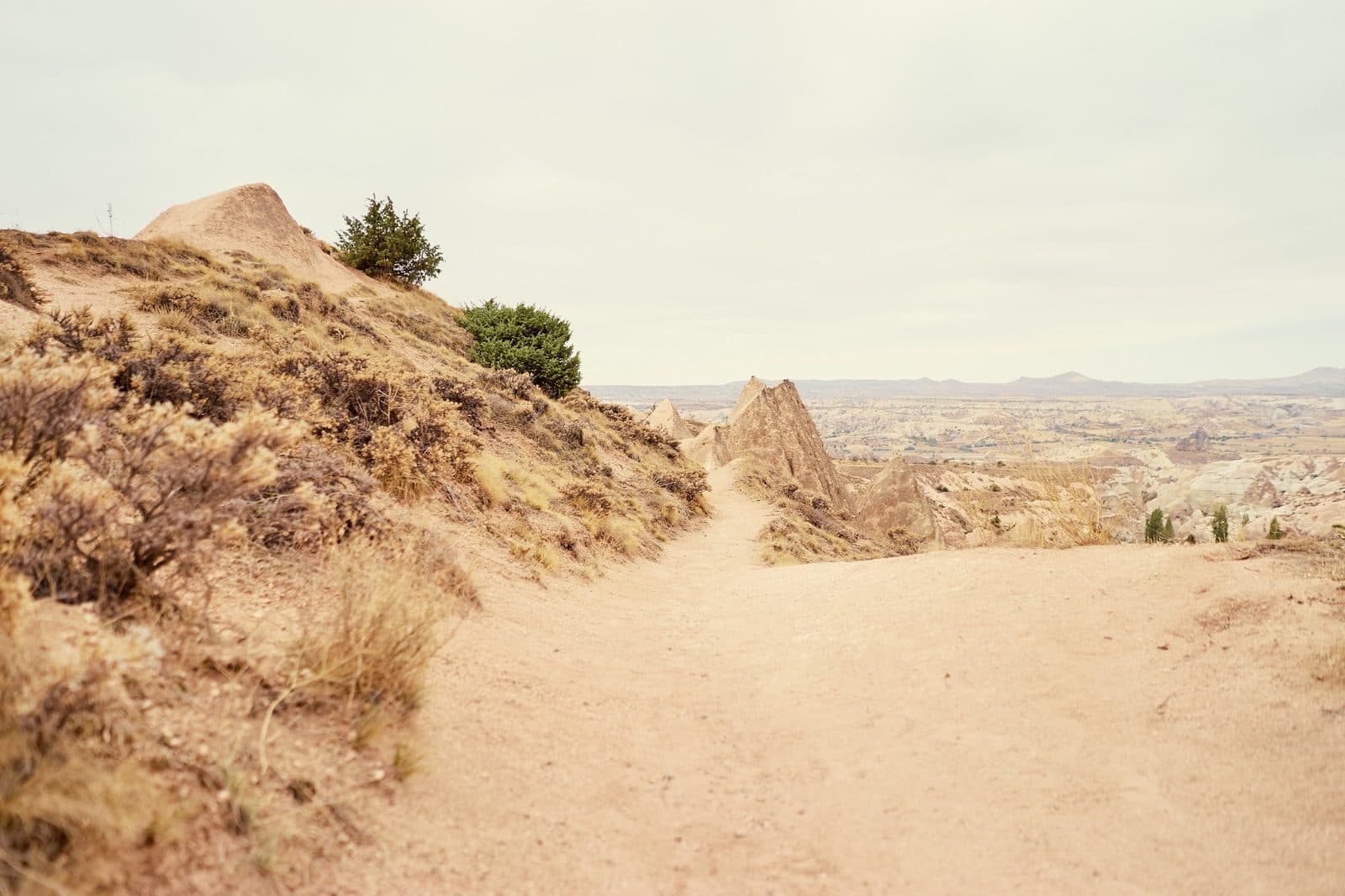 A dirt track through dry hills. Sunrise or Sunset Jeep Safari, arranged from The Owl Cave Hotel in Göreme, Cappadocia.