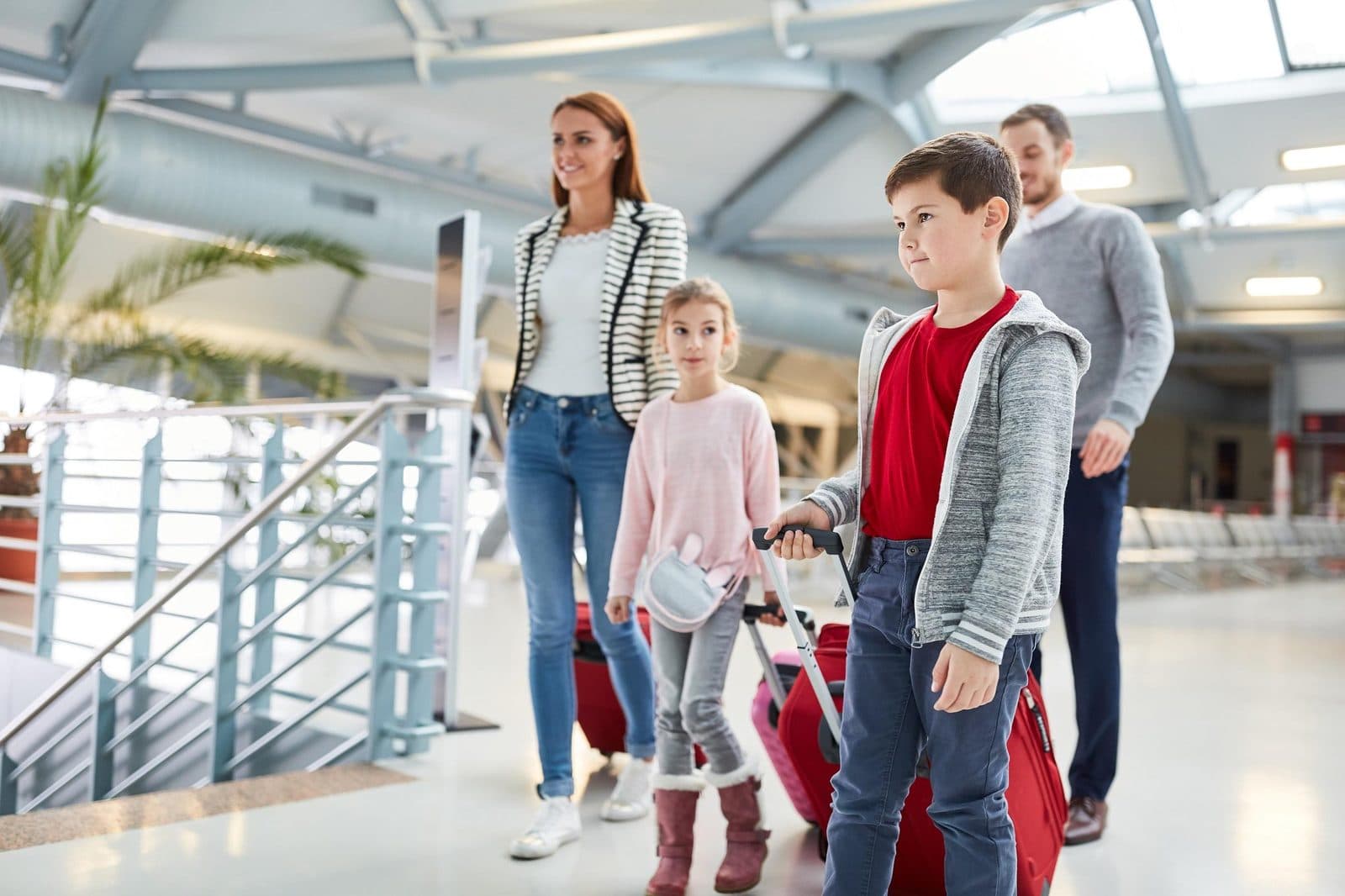 A family with luggage walking through a terminal. Nevşehir Airport Transfer, arranged from The Owl Cave Hotel in Göreme, Cappadocia.