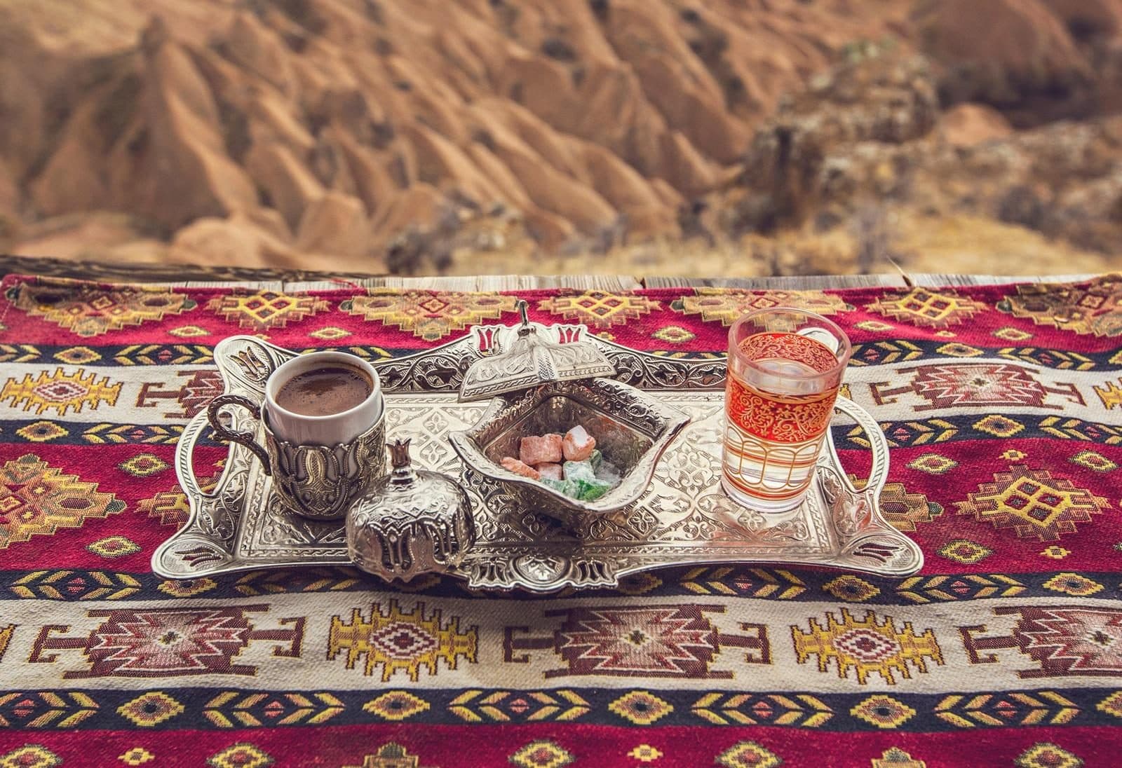 A Turkish coffee service set on a patterned cloth. Sand-Brewed Turkish Coffee Workshop, arranged from The Owl Cave Hotel in Göreme, Cappadocia.